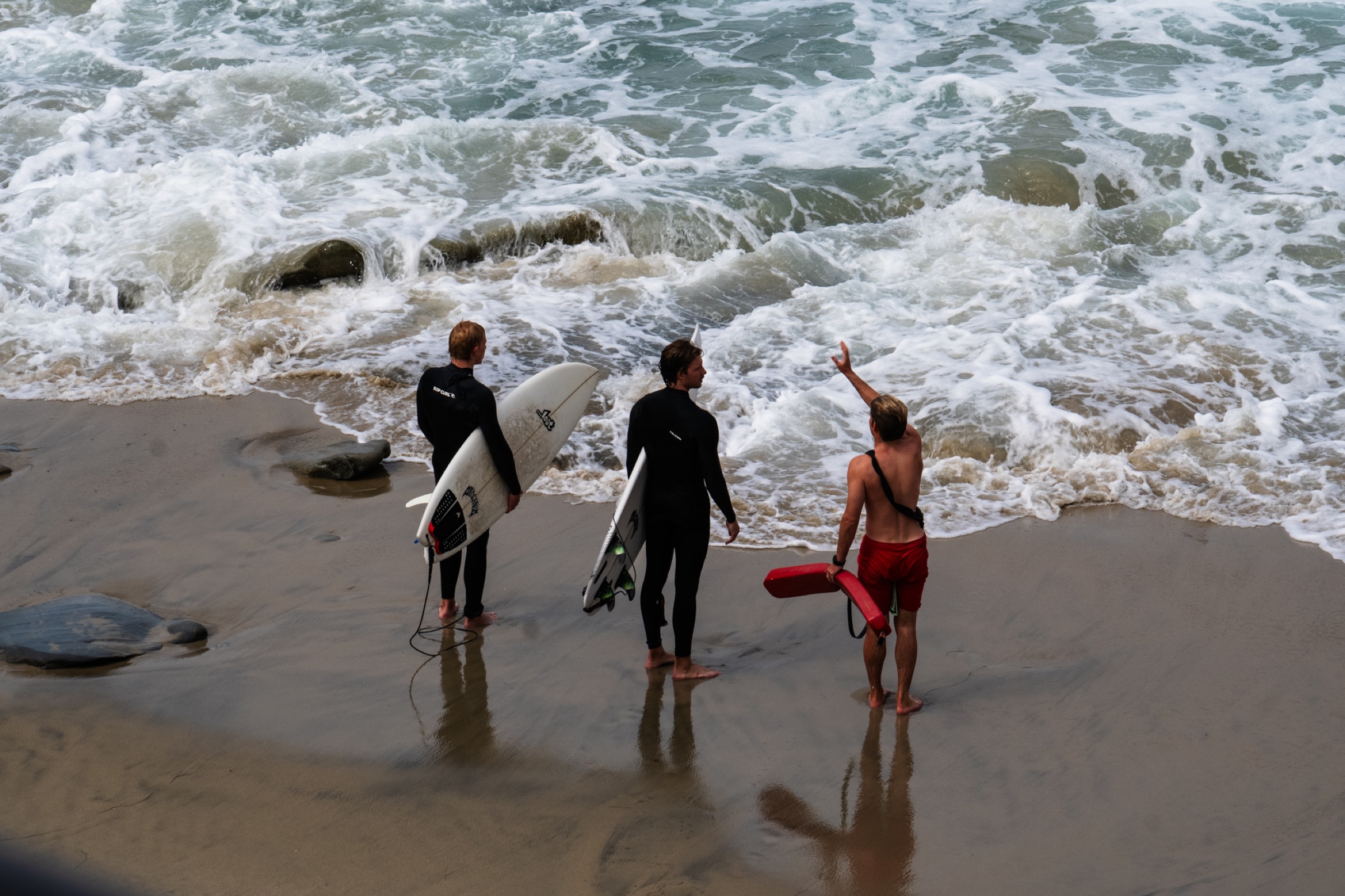 lifeguard briefing surfers at the beach
