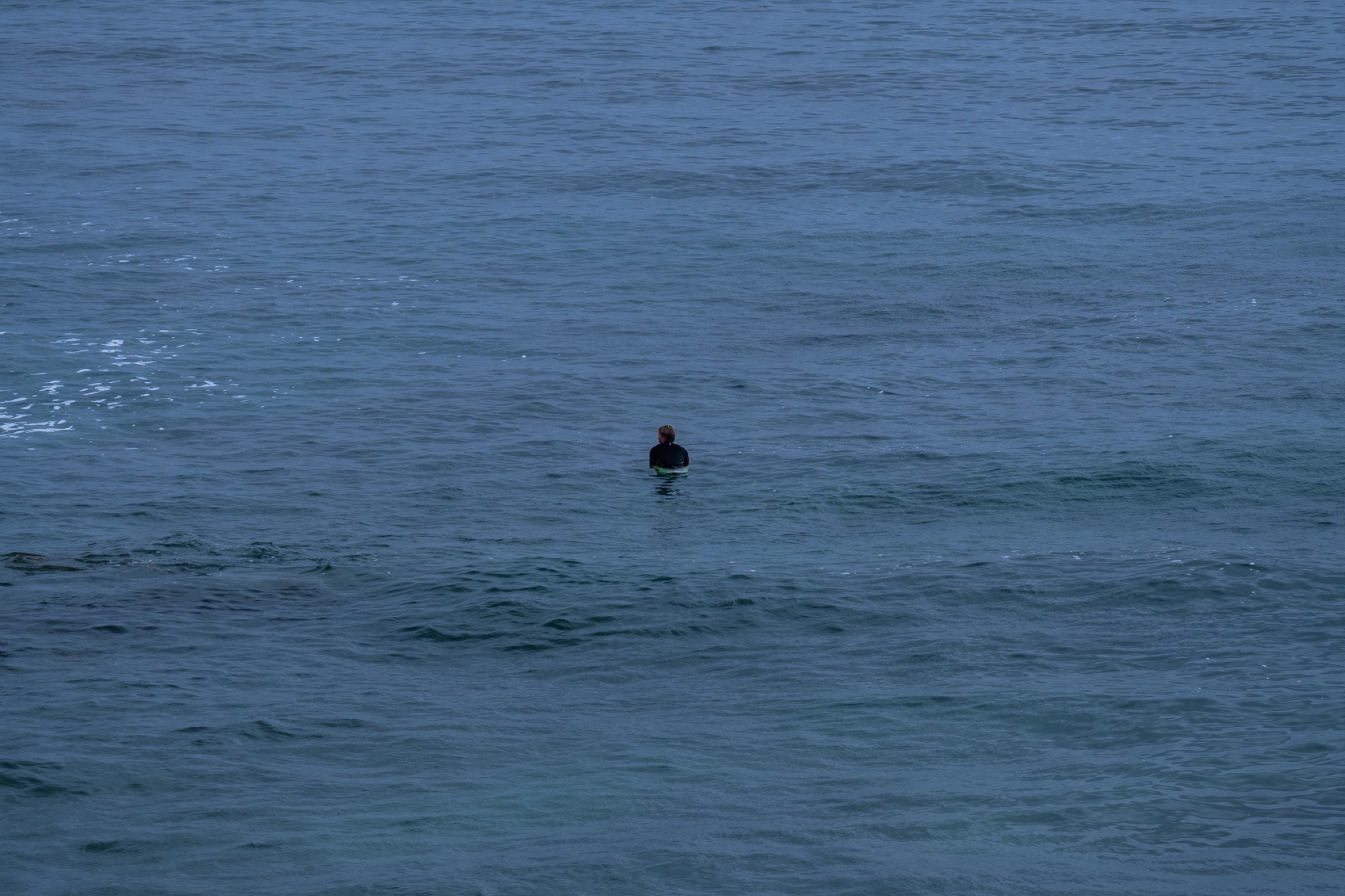 lone surfer in open water